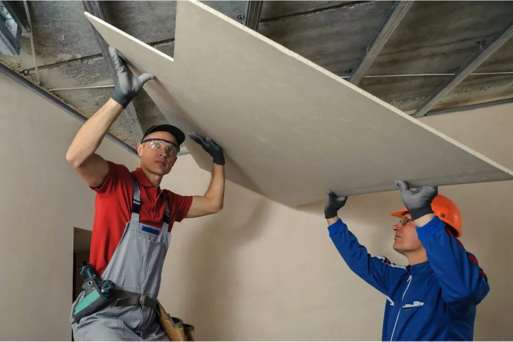 two contractors installing drywall