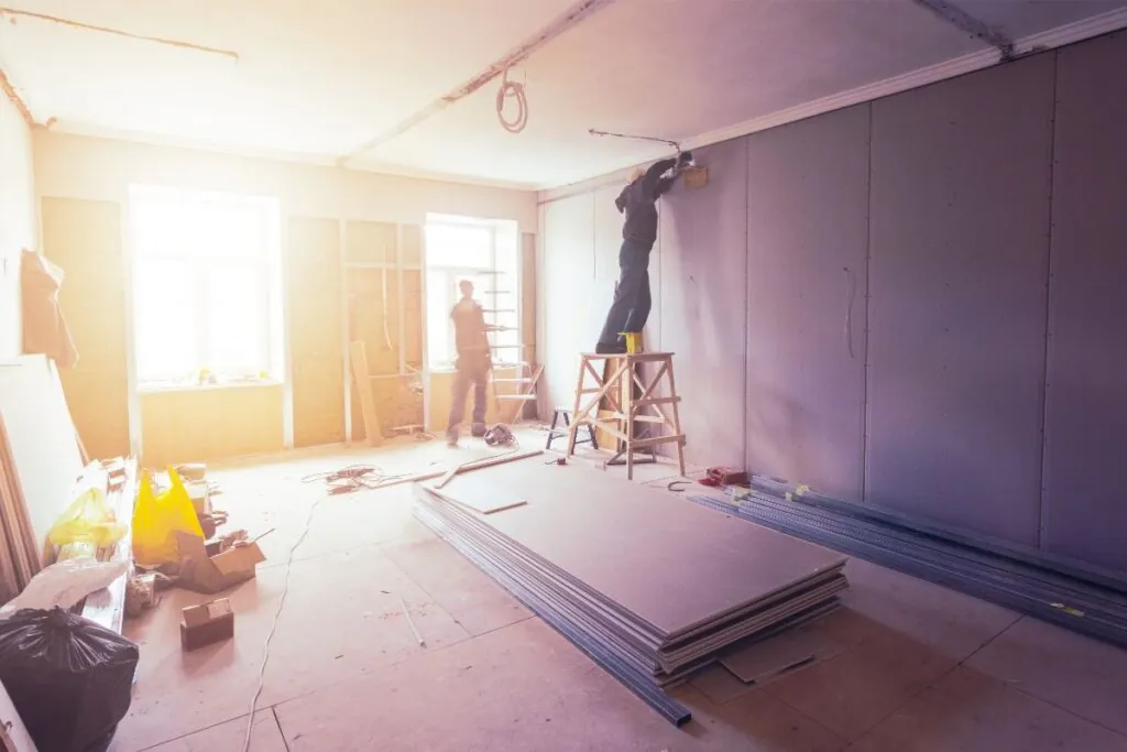 workers are installing plasterboard drywall